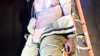 Macho stud held stiff and waiting to be tantalized rock-hard by his captor