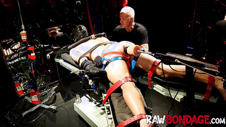 Shackled jock lounging face down being fisted in his bum