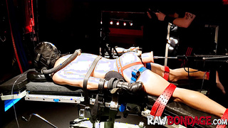 Shackled jock lounging face down being fisted in his bum