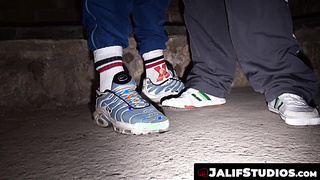 Draped fellows Greg Centuri and Miguel Bryan making out in the dark