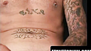 Bearded pillow-biter demonstrates tatts while milking manhood rock-hard