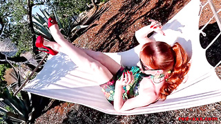Crimson GONZO inserts her puss with a plaything in the hammock