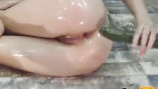 Well-Lubed dame put cucumber in the backside