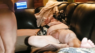 Mature dark haired housewife is blowing her paramour's spear while he is calming on the couch