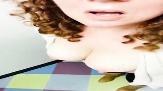 Meaty breasted stunner with lengthy, curly hair is posing on web cam, every once in a while