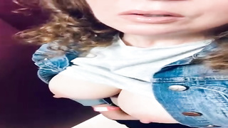 Meaty breasted stunner with lengthy, curly hair is posing on web cam, every once in a while