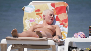 Goth dame with massive bra-stuffers on bra-less beach