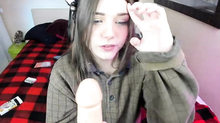 Blue- saw chick is deep throating a enormous, faux pecker and pummeling her cock-squeezing cootchie with it