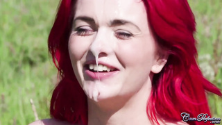 Crimson haired babe got a facial cumshot popshot in the fields, after providing a oral to her paramour