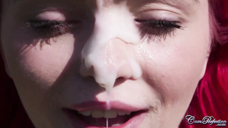 Crimson haired babe got a facial cumshot popshot in the fields, after providing a oral to her paramour