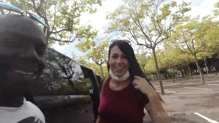 Dark haired female is inhaling a fat, dark-hued trunk in the nature and getting plunged with it