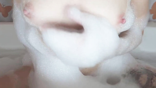 Tatted damsel is having a bathtub and impatiently kneading her labia, to make herself jism