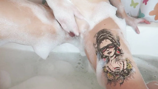 Tatted damsel is having a bathtub and impatiently kneading her labia, to make herself jism