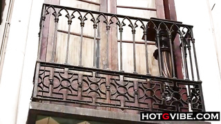 Crazy dark-haired is tugging and spurting on the balcony, in the middle of the day