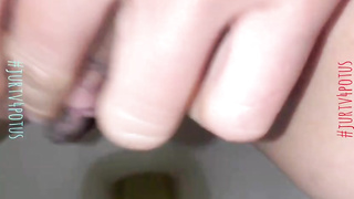 Jaws- watering close- up of a smooth-shaven, Japanese vagina while pissing in a public rest room