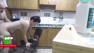 Dark haired housewife is blowing her paramour's shaft in the kitchen, before screwing his brains out