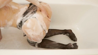Dark-Haired in ebony pantyhose and garter belt is soaping up and taunting in front of the camera