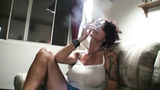 Brief haired mature is smoking a ciggy and deep-throating her paramour's boner to satisfy him