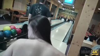 Dark haired female is in the mood for a casual pummel with her bowling colleague