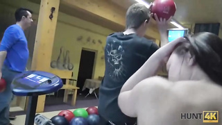Dark haired female is in the mood for a casual pummel with her bowling colleague