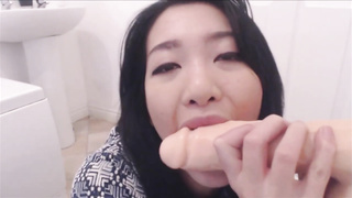 Huge-Chested, Chinese black-haired is deep throating a faux bone in front of the camera, to showcase her abilities