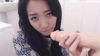 Huge-Chested, Chinese black-haired is deep throating a faux bone in front of the camera, to showcase her abilities