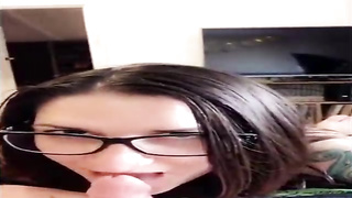 Unexperienced brown-haired with large, dark-hued glasses is throating her paramour's beef whistle in front of the camera