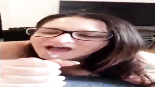 Unexperienced brown-haired with large, dark-hued glasses is throating her paramour's beef whistle in front of the camera