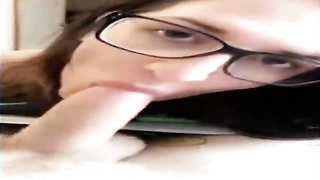 Unexperienced brown-haired with large, dark-hued glasses is throating her paramour's beef whistle in front of the camera