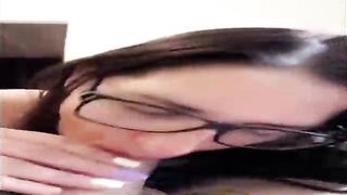 Unexperienced brown-haired with large, dark-hued glasses is throating her paramour's beef whistle in front of the camera