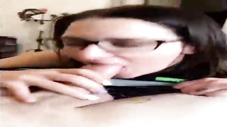Unexperienced brown-haired with large, dark-hued glasses is throating her paramour's beef whistle in front of the camera