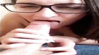 Unexperienced brown-haired with large, dark-hued glasses is throating her paramour's beef whistle in front of the camera