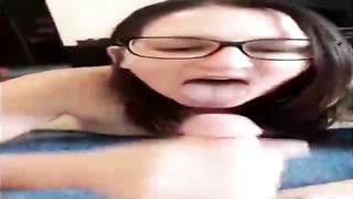 Unexperienced brown-haired with large, dark-hued glasses is throating her paramour's beef whistle in front of the camera