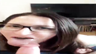 Unexperienced brown-haired with large, dark-hued glasses is throating her paramour's beef whistle in front of the camera