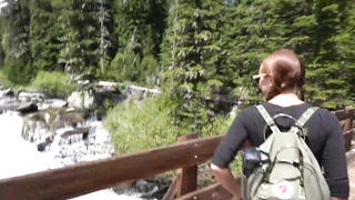 Ultra-Cute, crimson haired teenie with braids, Brandibraids is blowing lollipop in the nature, just for joy