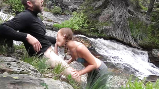 Ultra-Cute, crimson haired teenie with braids, Brandibraids is blowing lollipop in the nature, just for joy