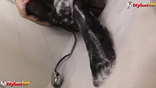 Crimson haired stunner with tats is dressed in a fantastic costume while tugging in the douche