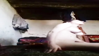 Unexperienced cougar with yam-sized funbags is posing in front of the camera with no clothes on