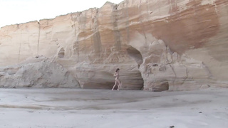 Slender teenager black-haired is posing naked near the rocks and opening up up broad to demonstrate her vag