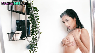 Showering asian masturbates and spreads pussy