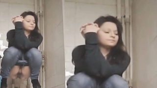 Every time gals are urinating in the univeristy restroom, there is a covert camera behind them