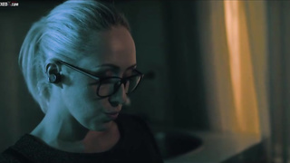 Christina is dressed in glasses and dark-hued tights while jacking in her guest room, late at night