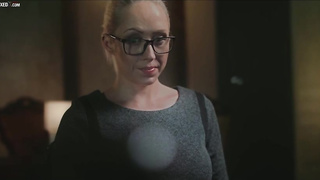 Christina is dressed in glasses and dark-hued tights while jacking in her guest room, late at night