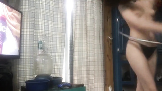 Puny boobed dark haired is using her hula hoop while without bra, in front of the web camera
