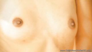 Wonderful Indian female is dancing in front of the camera and leisurely taking off her clothes