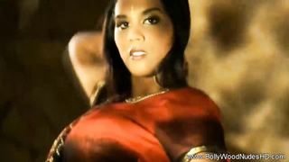 Exotic dark haired is leisurely taking off her clothes, while dancing in front of the camera