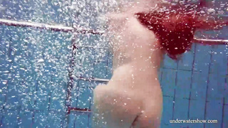 Crimson haired stunner, Nina Mohnatka got bare and stretched her gams broad open in the swimming pool