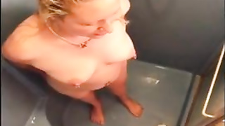 Mature blond is stroking in the douche, in front of the camera and lovin’ it a pile